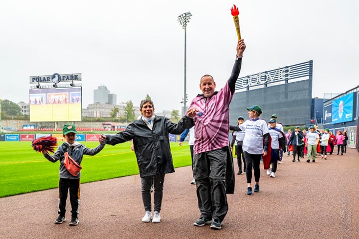 UMass Cancer Walk co-founder Dottie Manning leading the survivor lap alongside cancer survivor David Tatro.