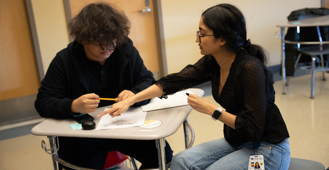 Medical student Ariya Jacob (right) tutors a North High School ESL student