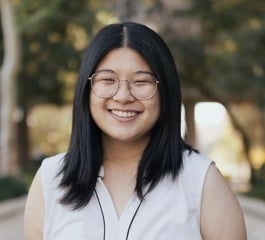  A head-and-shoulders outdoor photo of Emerald smiling. 