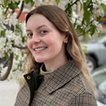 woman with light hair and plaid coat