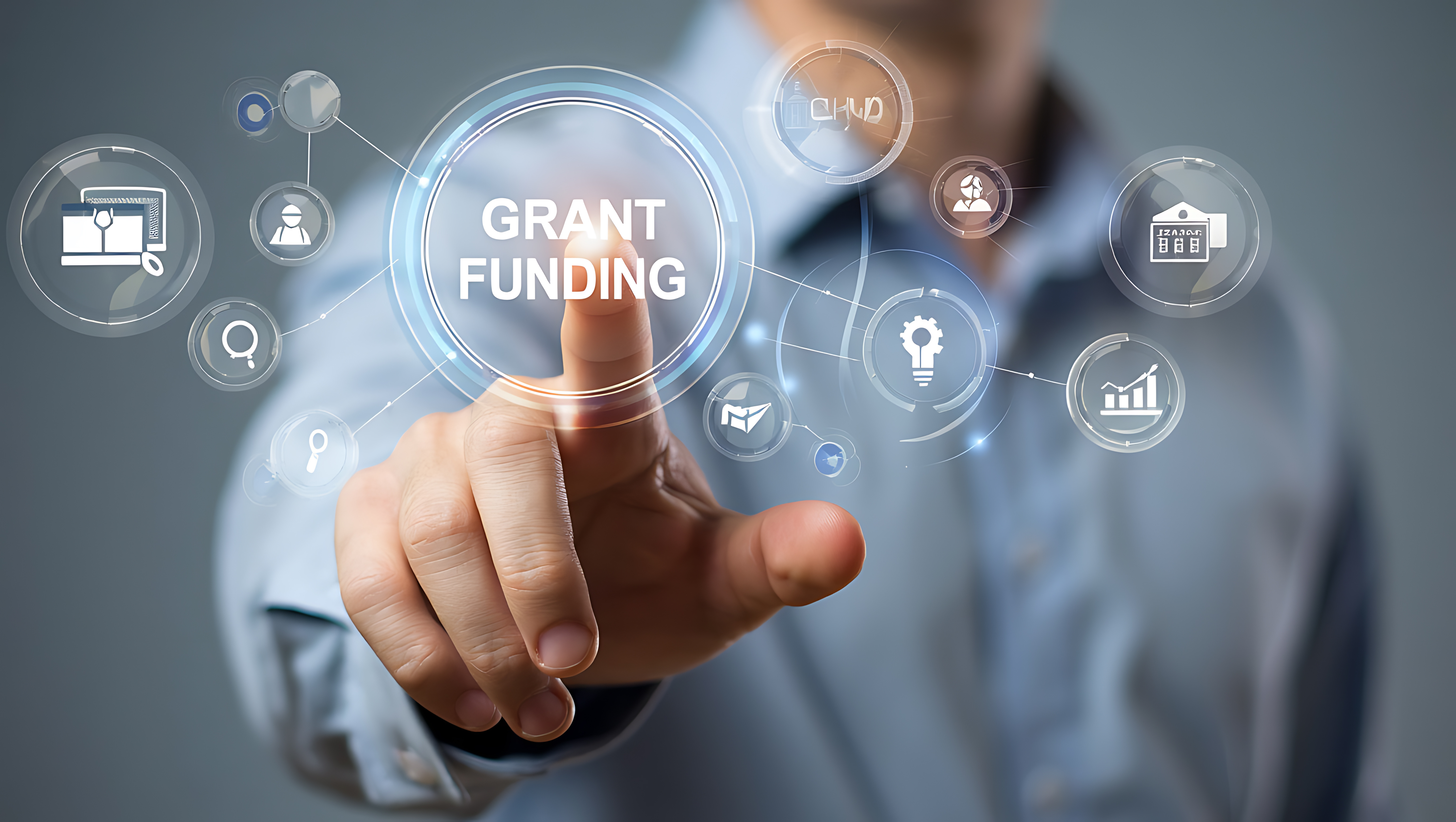 A finger pressing on the words "Grant Funding"