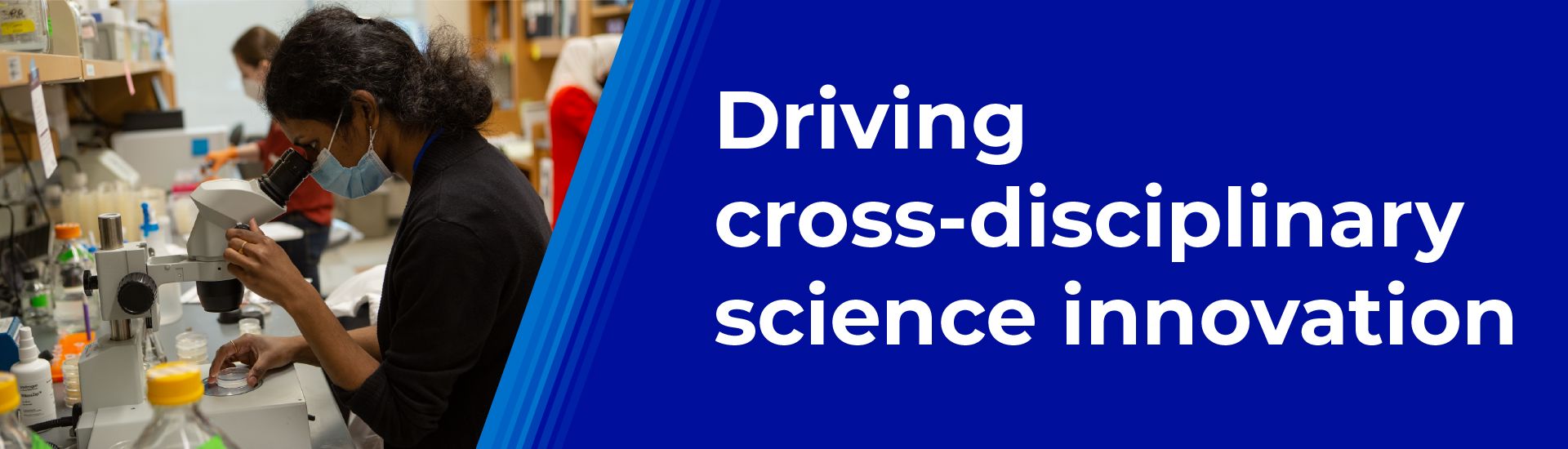 A scientist looking through a microscope next to the text Driving cross disciplinary science innovation.