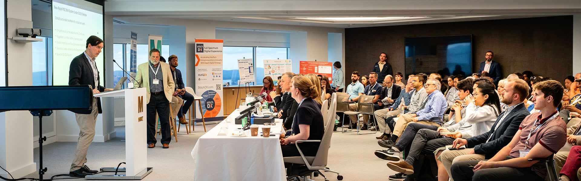 Image of a speaker and an audience at a CAPCaT event