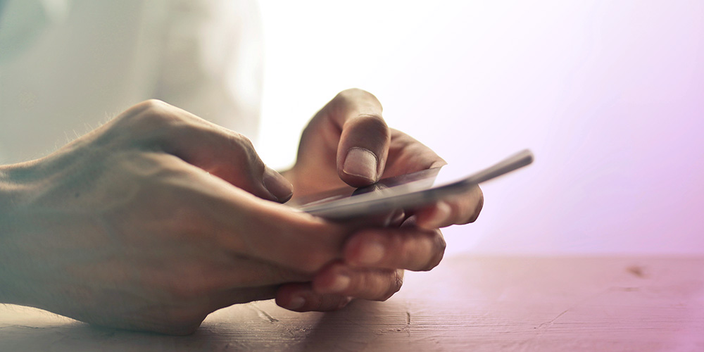 Close up of hands holding cellphone