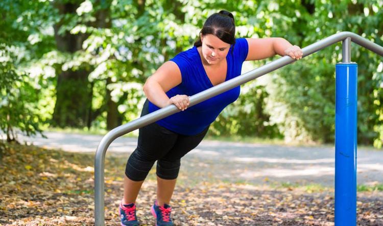 Obese woman exercising outside