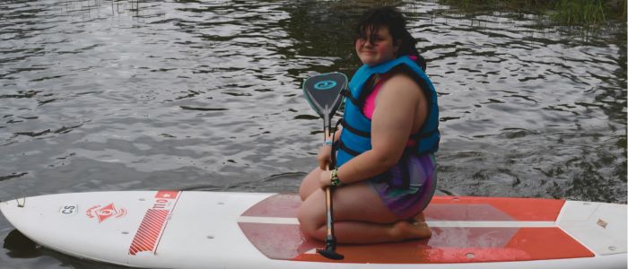 Jenna posing on a Paddle Board
