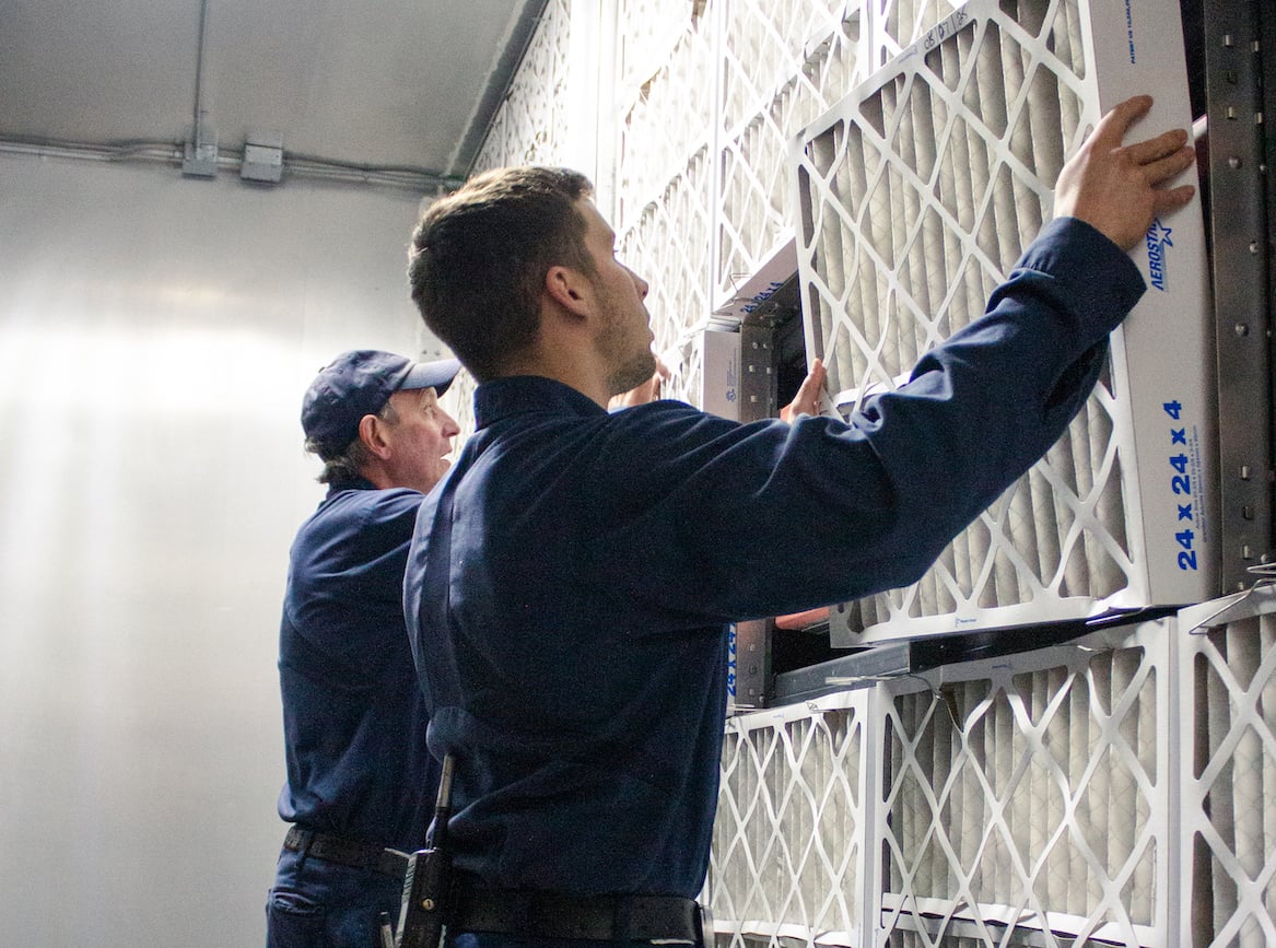  Maintenance staff replacing air filters