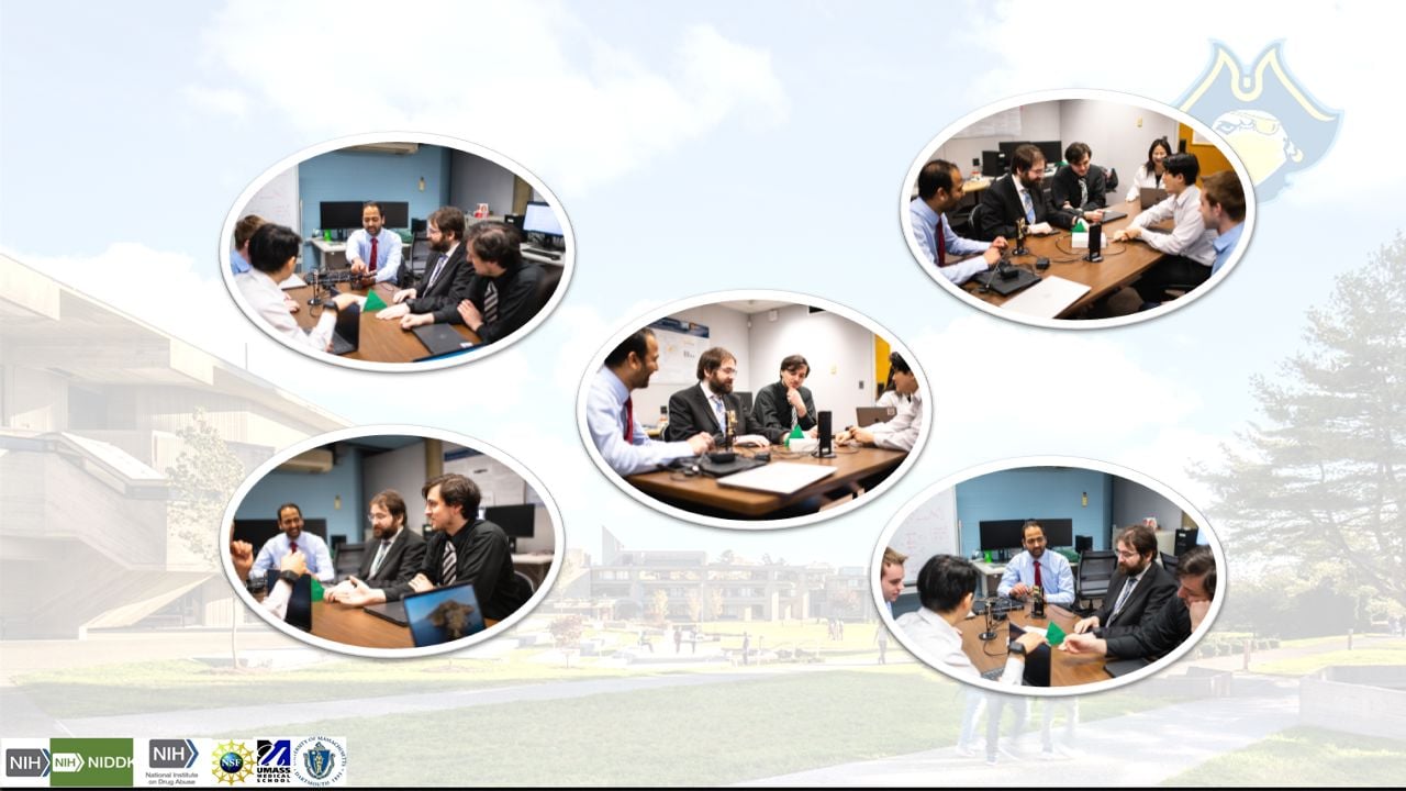 Lab members sitting around a conference table within the office