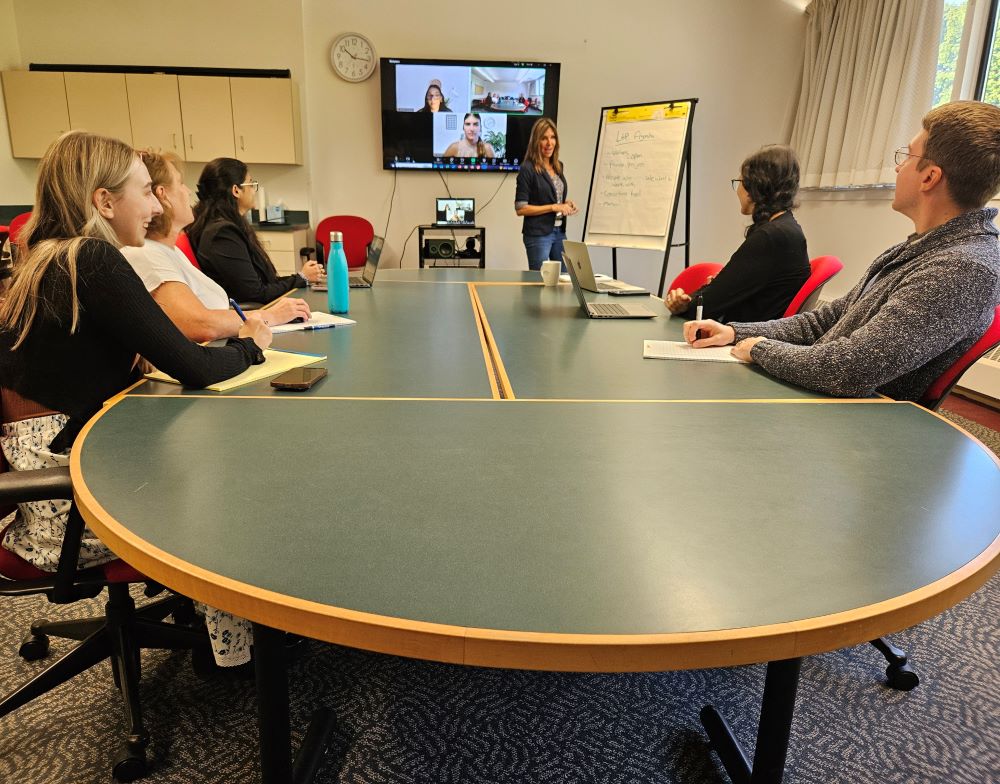 group of people sitting around a conference table