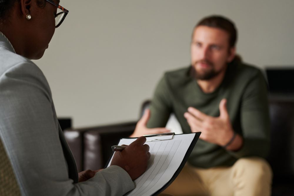 black female counselor counseling white male