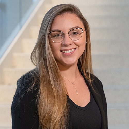white young woman with dark blond hair and glasses