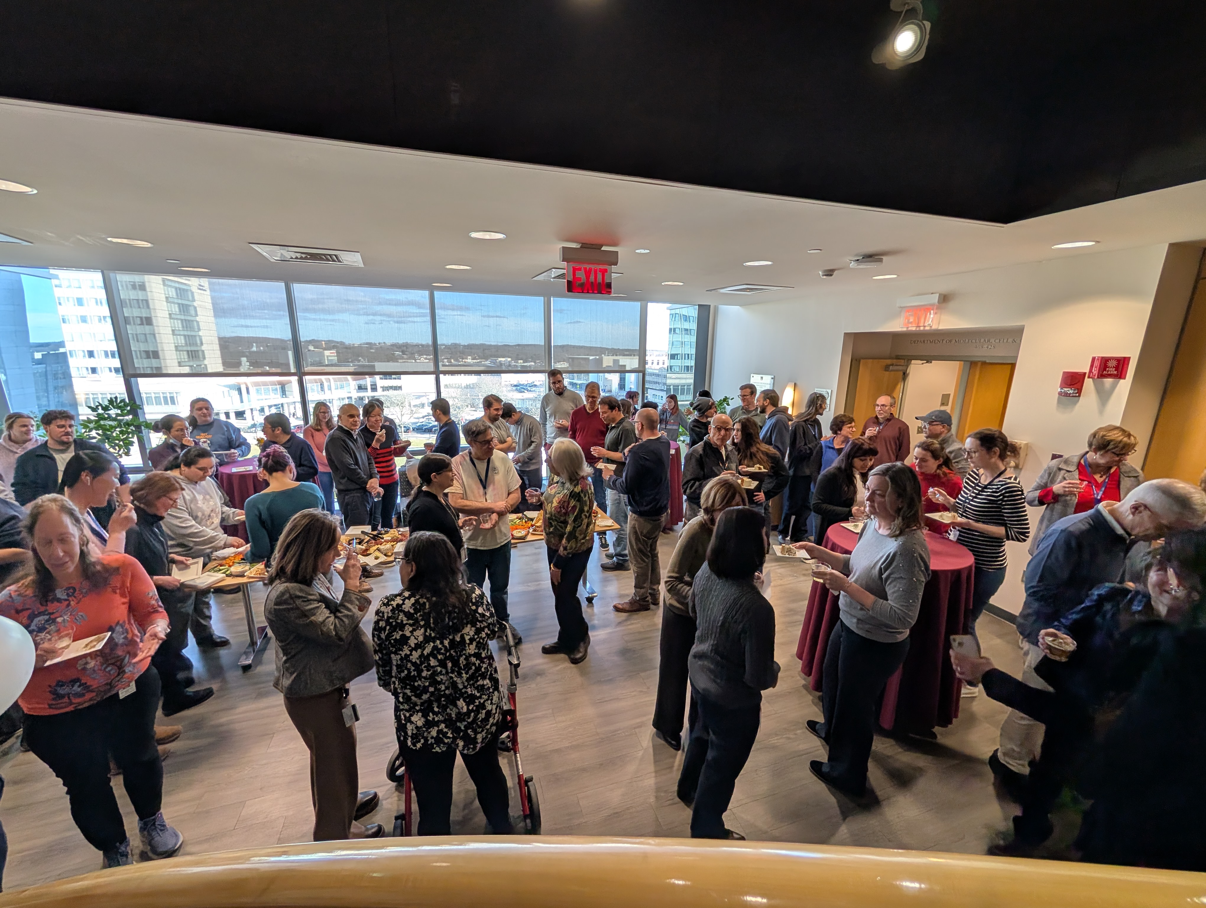 Candid photo of attendees socializing and talking at the retirement party.