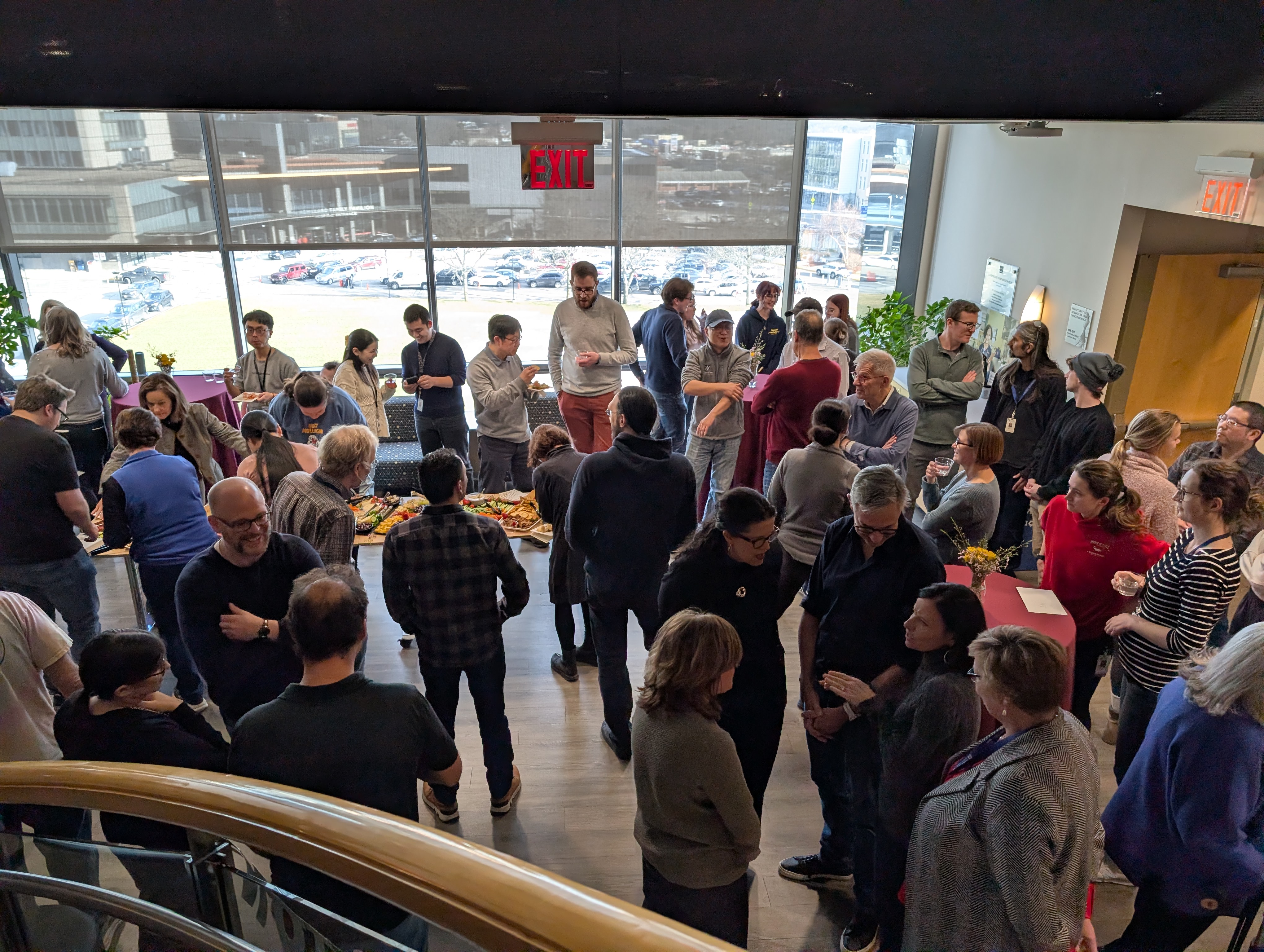 Candid photo of attendees socializing and talking at a retirement party.
