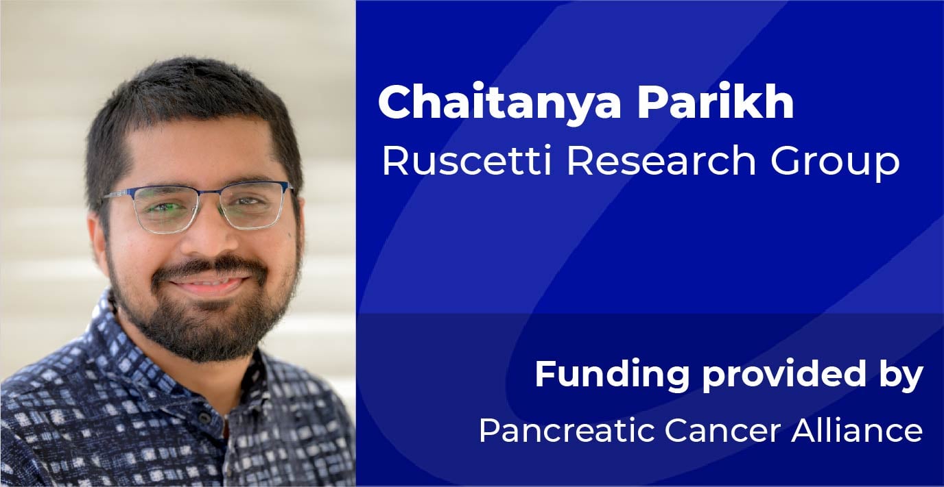 A researcher stands beside a blue information panel displaying the text: “Chaitanya Parikh, Ruscetti Research Group. Funding provided by Pancreatic Cancer Alliance.”