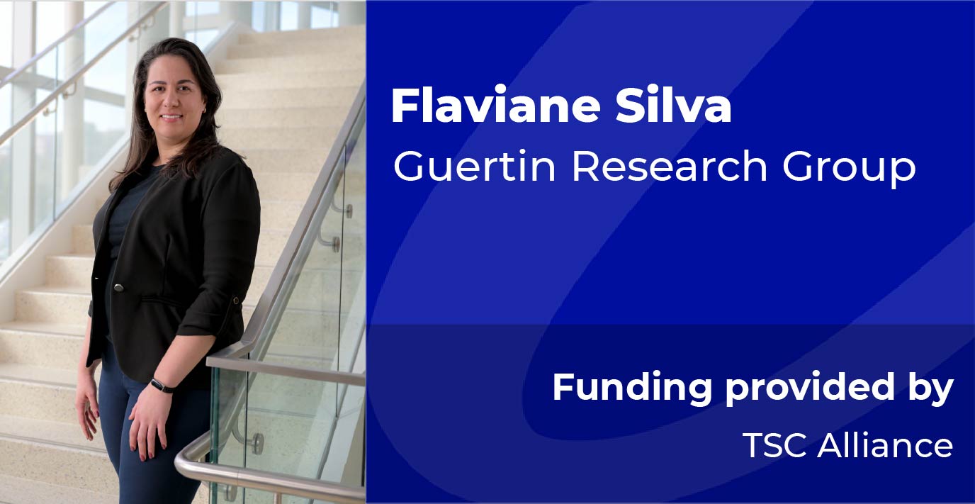 A researcher stands on a staircase beside a blue information panel displaying the text: “Flaviane Silva, Guertin Research Group. Funding provided by TSC Alliance.”
