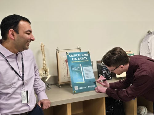 Kyle Rossi, MD, signing his book release poster