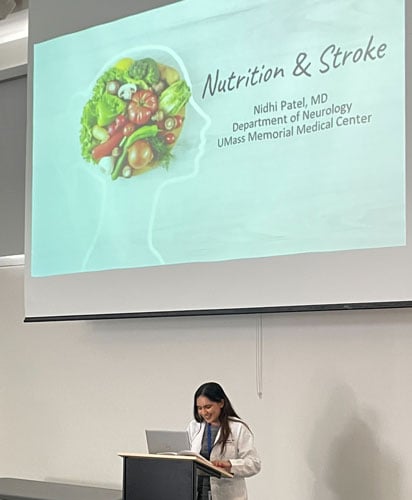 Nidhi Patel, MD, resident standing at podium