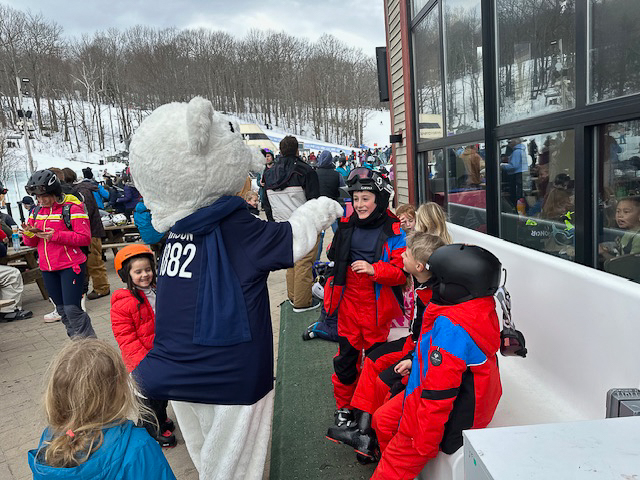Children meet mascot Orson at ski lodge