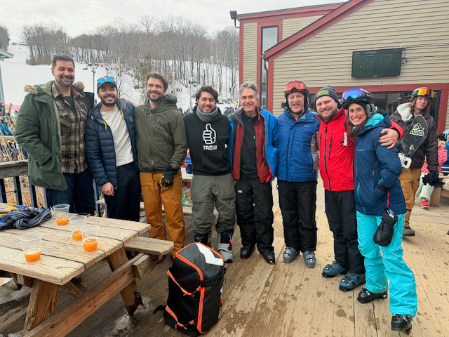 skiers take break and pose at lodge