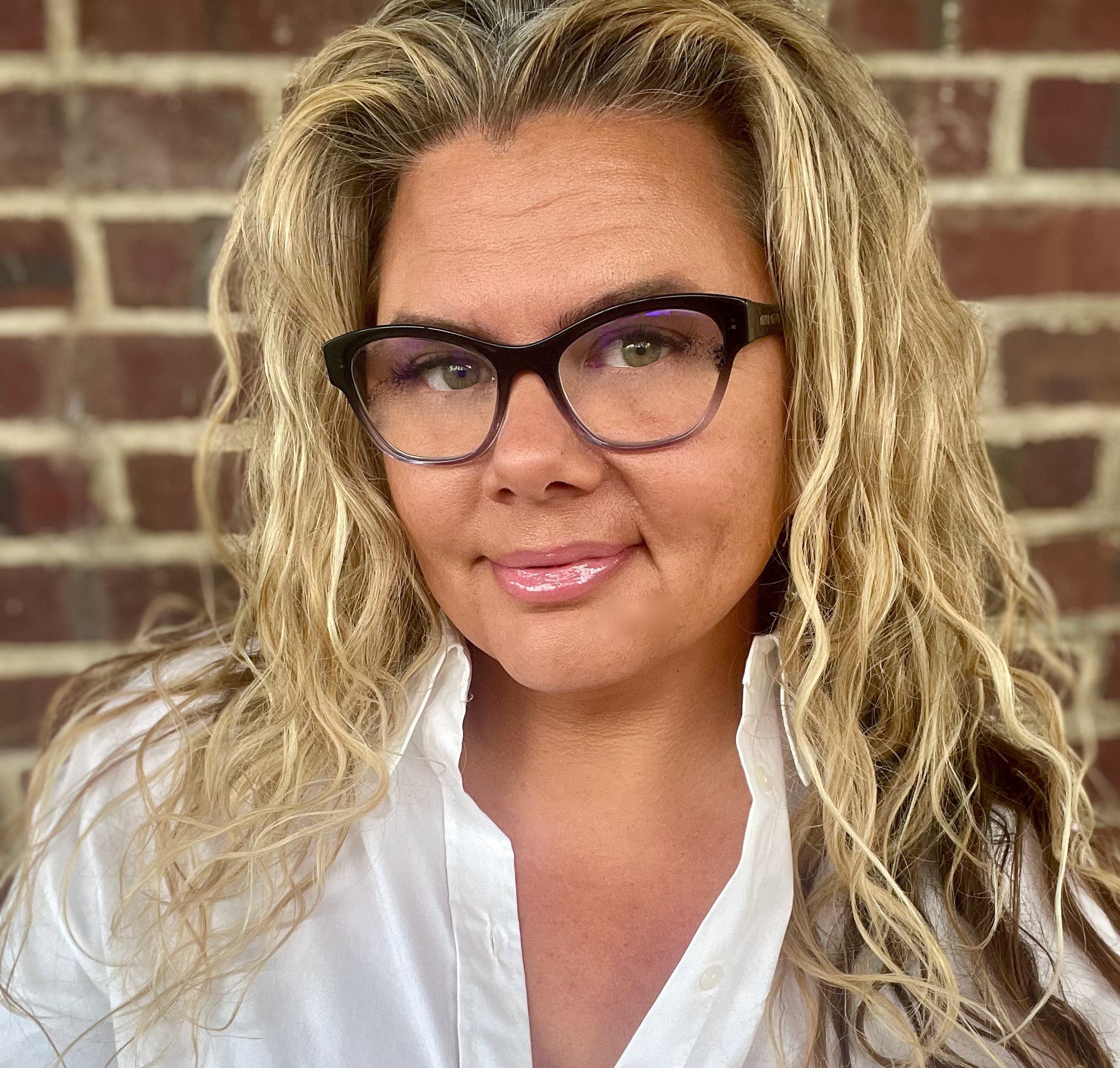 woman with long blonde hair and glasses