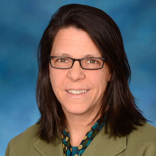 white woman with dark hair and glasses