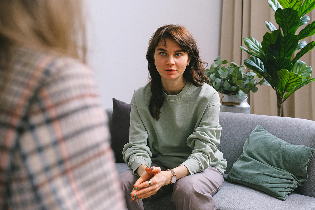 white woman on a couch talking to a therapist