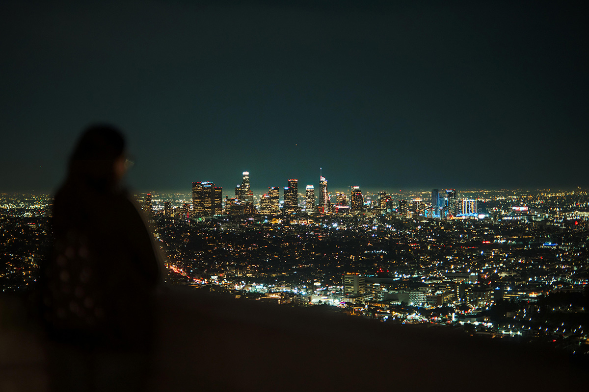 woman overlooking city at night