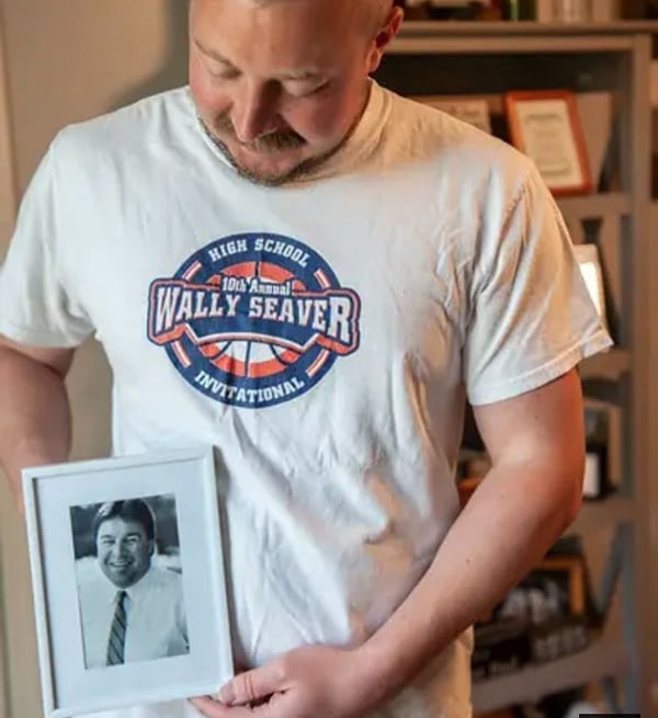 Paul Seaver holding a framed photo of his father.