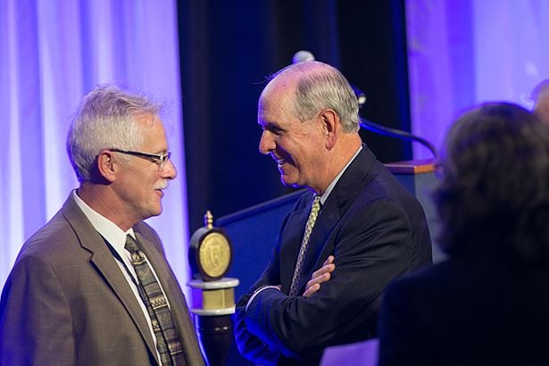 GSBS Dean Anthony Carruthers spends a moment with Chancellor Michael F. Collins before the dean’s last official ceremony at UMMS before stepping down from the dean’s post early next year.