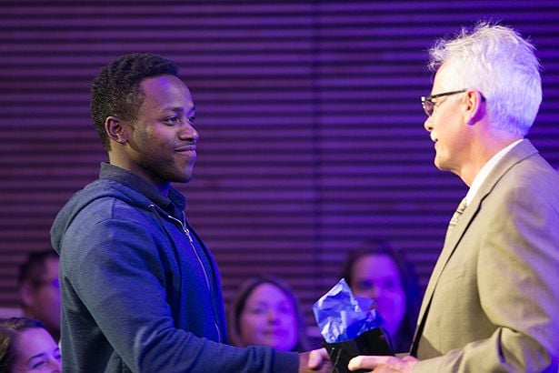 Jacqueto Zephyr accepts a gift from the dean.