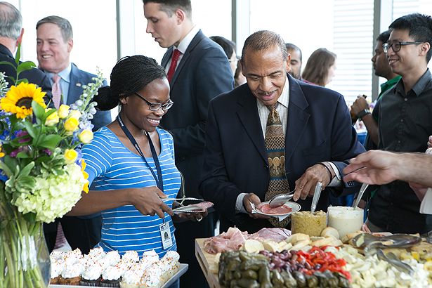 Robert Layne and GSBS student Chido Kativhu enjoy some refreshments at the GSBS reception.