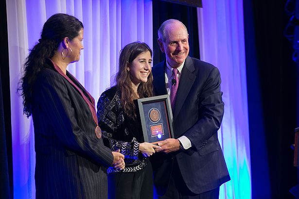 Marian Walhout joins Chancellor Collins as he presents a medal to Noor Semaan in honor of her late father, Maroun Semaan. Dr. Walhout holds The Maroun Semaan Chair in Biomedical Research.