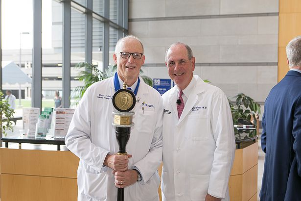 Michael Hirsh, as recipient of the 2017 Chancellor’s Medal for Distinguished Service, stands with Chancellor Collins before leading the procession.