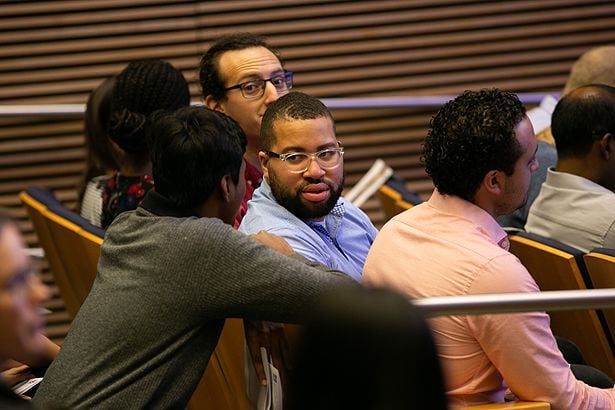 Kristopher Holloway, of the Anaclet and Zhang labs, awaits the start of the recognition ceremony.