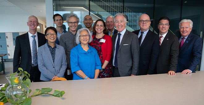 Mark Fuller; Julie Chen; Jake Auchincloss; Victor Ambros; Candy Lee; Kirk Taylor, MD, of the Massachusetts Life Sciences Center; Renee Wegrzyn; Michael Collins; Richard Neal; James McGovern; Javier Reyes; and Marty Meehan smiling and standing together