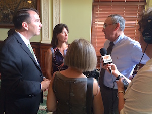 Reps. James Cantwell (left) and Carolyn Dykema speak with Mark S. Klempner, executive vice chancellor of MassBiologics.