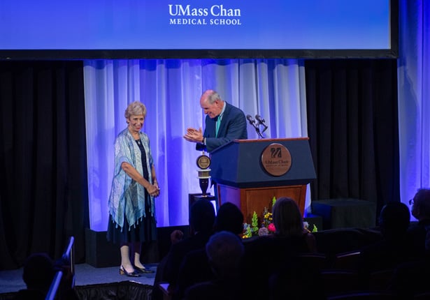 Joan Vitello-Cicciu, PhD, is congratulated by Chancellor Michael F. Collins