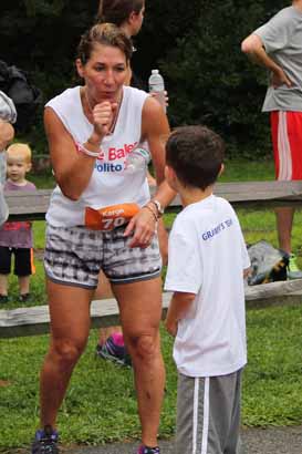 Karyn Polito greets Rhys Adams, Gov. Cellucci's 7-year-old grandson, at the finish line.