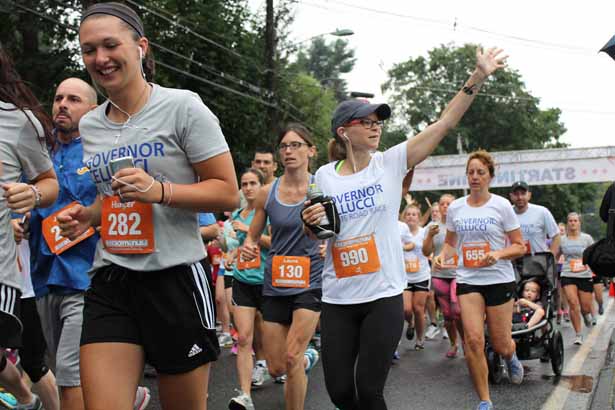 Hunter Drake (282), of Hudson, and Amy Wiswell (990), of Townsend, are among the hundreds of runners off at the starting line.