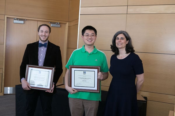 From left, Noah Silverstein and Jiayi Fan accept Curriculum Achievement Awards from Associate Dean Mary Ellen Lane.