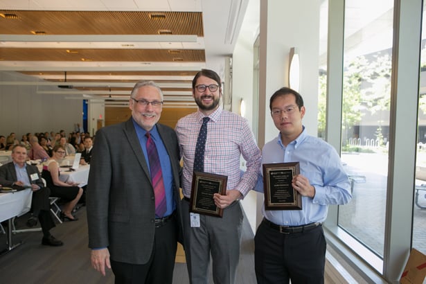 Sheldon Benjamin, MD, presents the Aaron Lazare Award for Psychiatry to Taylor Young and Mark Fusunyan.