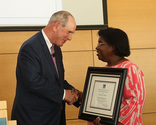 Chancellor Michael F. Collins congratulates Chancellor’s Award winner Colette Dieujuste.