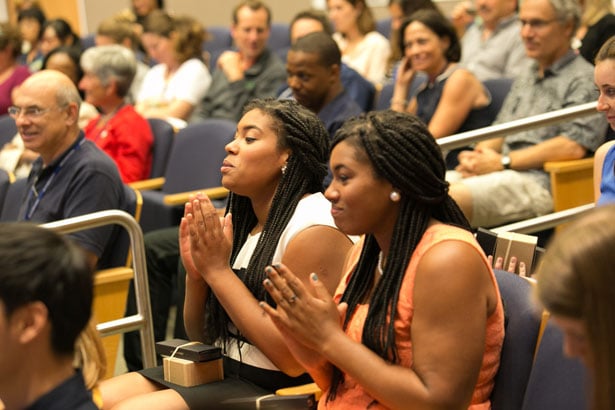 Asia Matthew, of the Shaw lab, and Ashley Matthew, of the Schiffer lab, applaud their GSBS classmates.