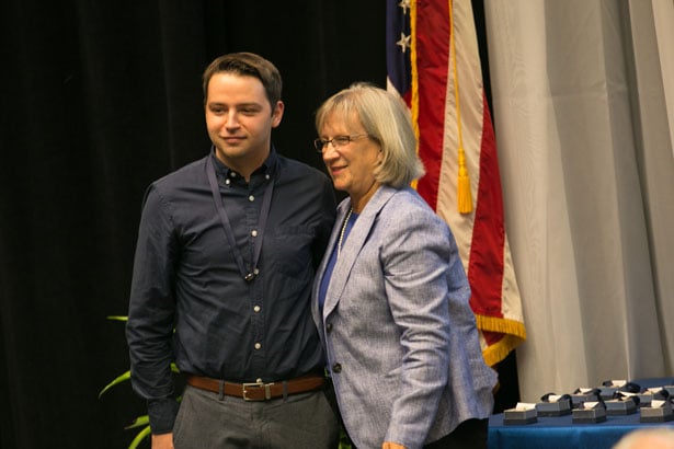 Nicholas Chasse accepts his nursing pin from Dr. Seymour-Route.