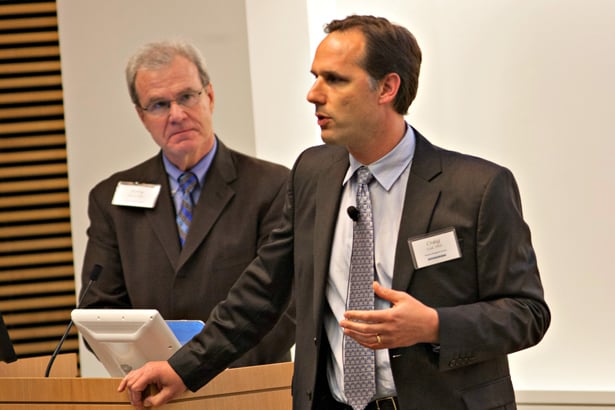 Craig Ceol presents “Fishing for cancer genes: finding new melanoma genes and drug targets” as Dean Terence Flotte looks on.