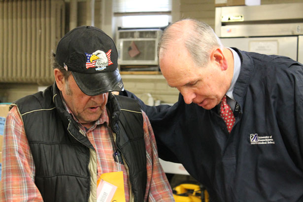 Chancellor Michael F. Collins shares a word with one of the hundreds of veterans who participated in the annual Veterans Inc. Harvest Day event.