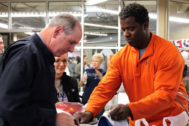 UMass Chan Medical School’s Chancellor Michael F. Collins, Jesse Edwards and Stephanie Renk place turkeys in a veteran’s cart.