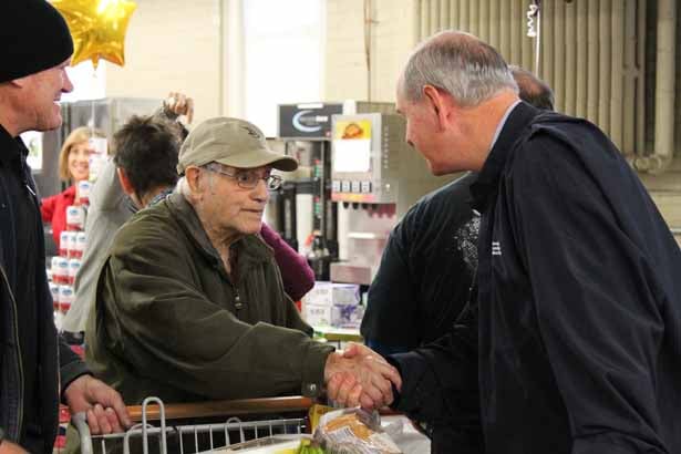 Chancellor Collins receives a warm handshake from a veteran.