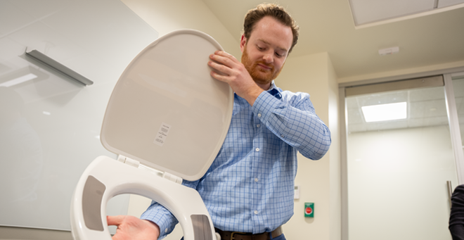 Paul Hartin Jr. shows the COMMODE seat