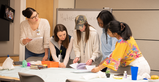 Second year DNP students work their way through an escape room puzzle.